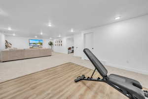 Workout area with recessed lighting and light colored carpet