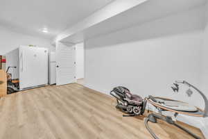 Misc room with wood finished floors and baseboards