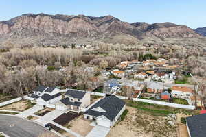 Aerial view of residential area featuring a mountainous background