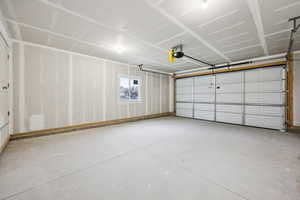 Garage featuring a garage door opener