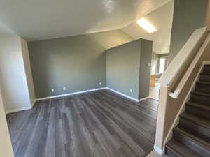 Bonus room with stairway, wood finished floors, and lofted ceiling