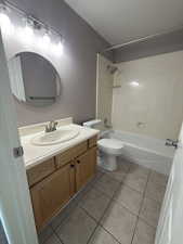 Full bathroom with shower / tub combination, vanity, and light tile patterned flooring