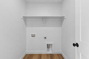 Laundry room featuring electric dryer hookup, wood finished floors, and washer hookup