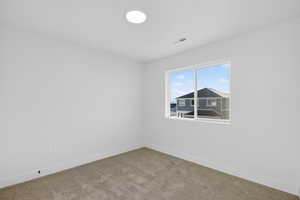 Empty room with baseboards and carpet