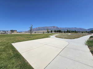 Surrounding community featuring a mountain view and a yard