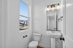 Bathroom with toilet and baseboards