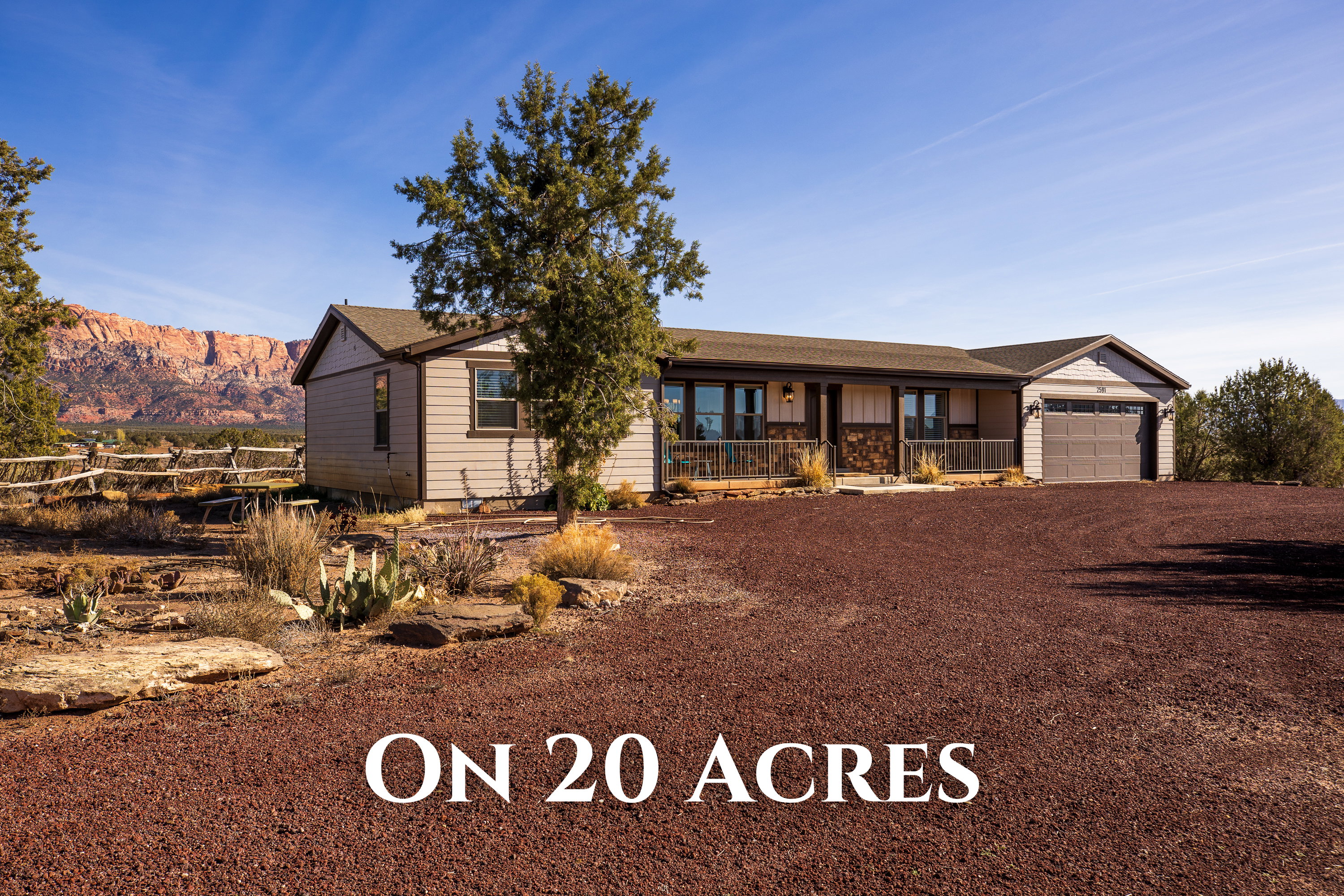 Ranch-style home featuring a porch, dirt driveway, an attached garage, roof with shingles, and a mountain view