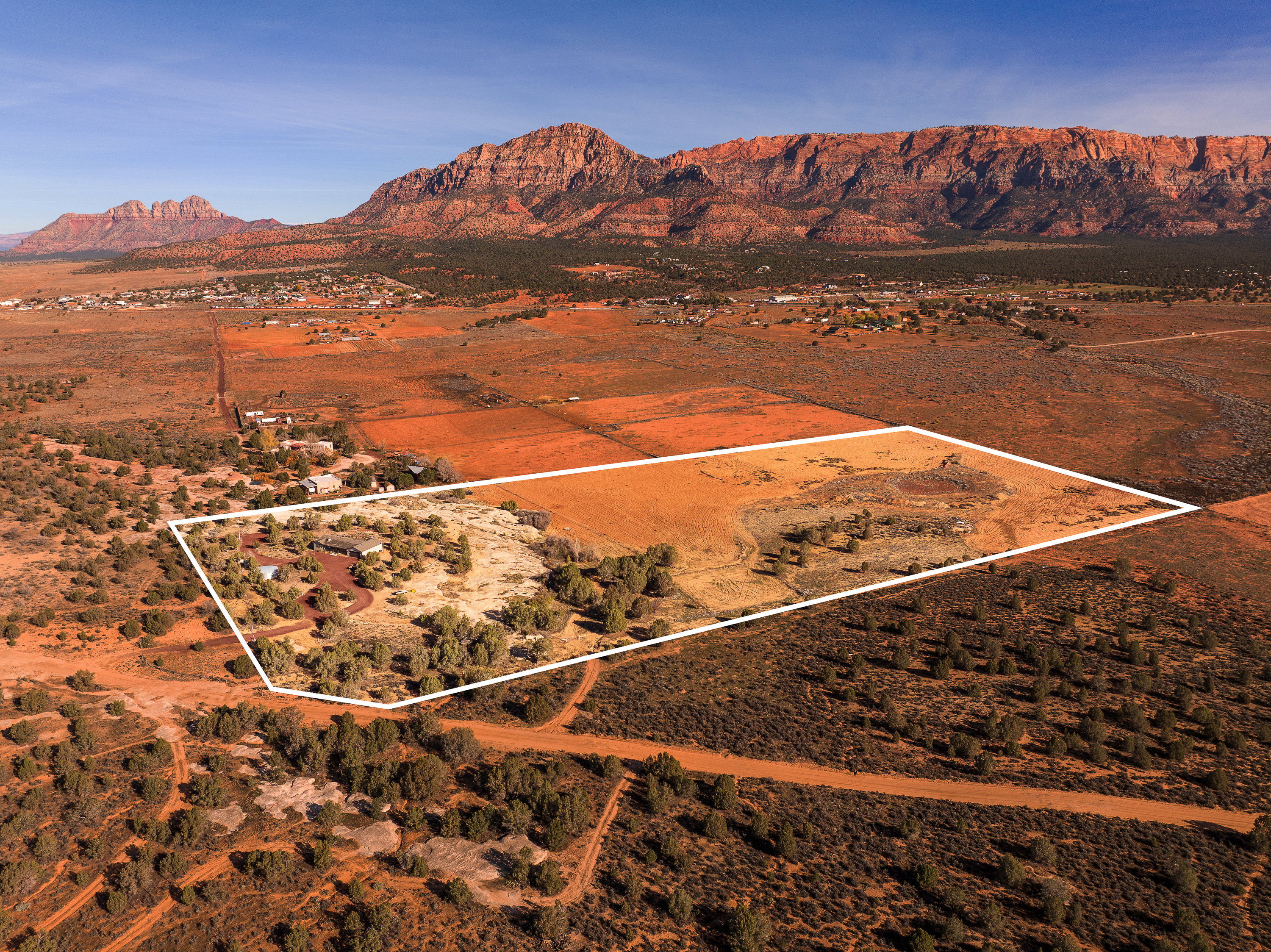 Overview of rural landscape with property boundaries highlighted and mountains
