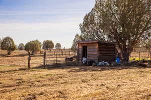 View of shed with a view of rural / pastoral area and a gate