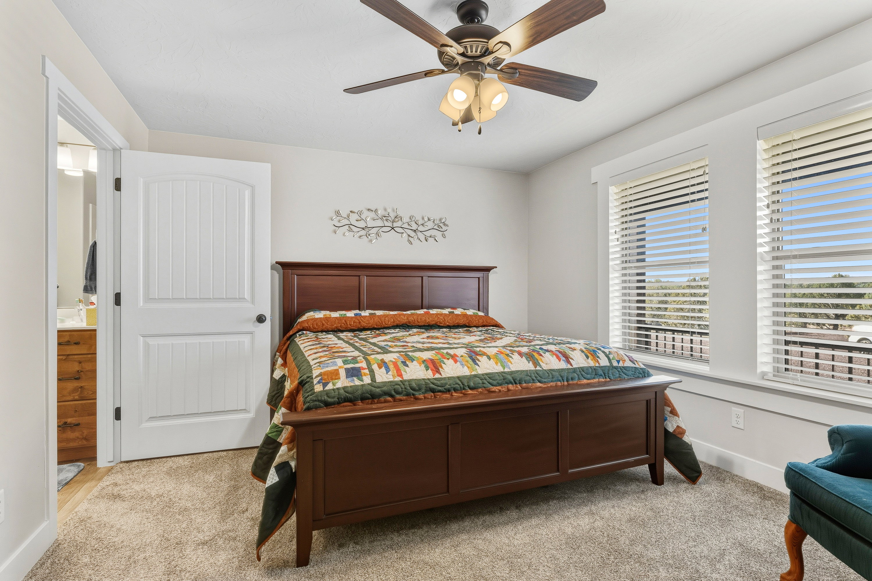 Bedroom with light carpet and ceiling fan