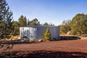 View of property exterior featuring an outbuilding