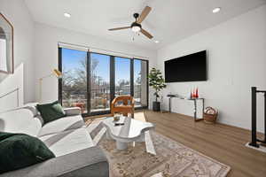 Living area with wood finished floors, a ceiling fan, and recessed lighting