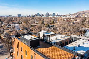 Drone / aerial view of city skyline and a mountainous background