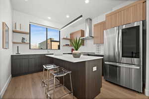 Kitchen with open shelves, modern cabinets, a breakfast bar, decorative backsplash, and recessed lighting