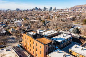 Aerial view of city skyline and a mountain backdrop