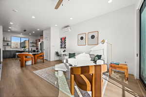 Living area with light wood-style flooring, recessed lighting, and a ceiling fan