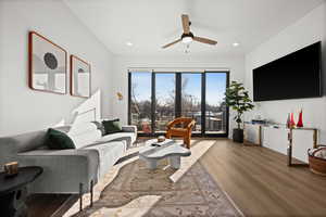 Living area featuring light wood-style floors, a ceiling fan, and recessed lighting
