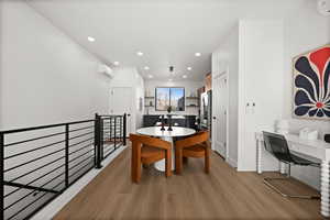Dining space with light wood-type flooring and recessed lighting