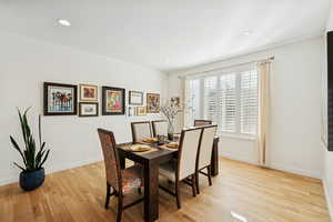 Dining room featuring light wood finished floors and recessed lighting