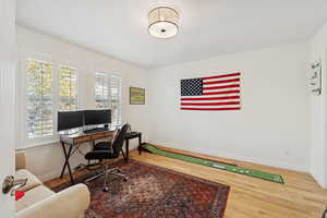Home office with baseboards and light wood-type flooring