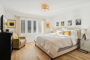 Bedroom featuring light wood-style flooring and baseboards