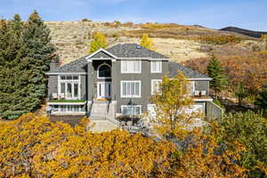 View of front of house featuring a chimney, stucco siding, and a mountain view
