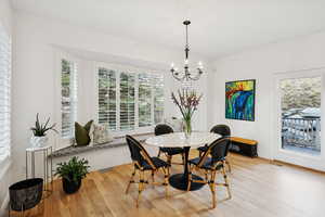 Dining space with a chandelier and light wood finished floors