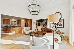 Living area with recessed lighting, stairway, and light wood-style floors