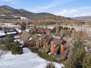Snowy aerial view with a mountain view and a residential view