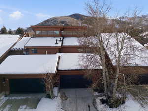 View of front facade with a mountain view and concrete driveway