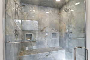 Bathroom featuring a marble finish shower