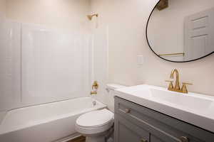 Full bathroom with shower / bath combination and vanity