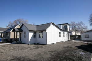 View of property exterior featuring board and batten siding and roof with shingles