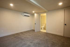Finished below grade area with recessed lighting, carpet, and a wall mounted AC