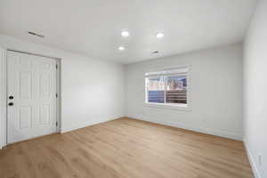 Unfurnished room featuring light wood-style floors and recessed lighting