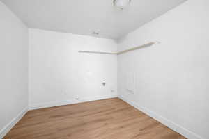 Spare room featuring light wood-type flooring and baseboards