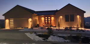 View of front facade featuring an attached garage and driveway