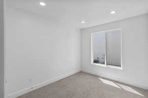 Unfurnished room featuring carpet floors and recessed lighting