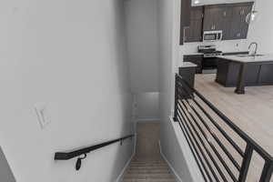 Stairs featuring carpet flooring and wood finished floors