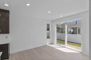 Unfurnished dining area featuring light wood finished floors and recessed lighting
