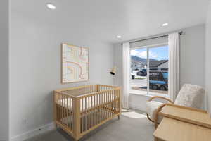 Bedroom featuring carpet, a nursery area, recessed lighting, and a mountain view