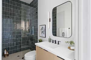 Bathroom featuring vanity and tiled shower