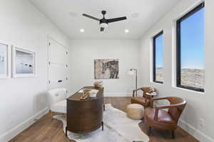 Sitting room featuring wood finished floors, ceiling fan, and recessed lighting