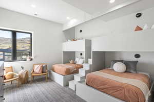 Carpeted bedroom featuring recessed lighting and a mountain view