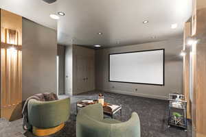 Carpeted cinema room with baseboards and recessed lighting