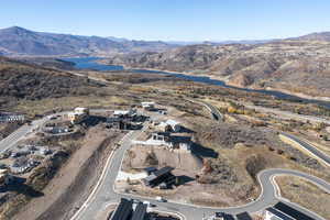 Aerial view of property's location featuring a water and mountain view