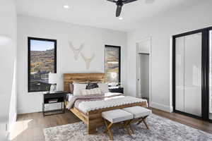 Guest bedroom with recessed lighting, dark wood finished floors, and ceiling fan