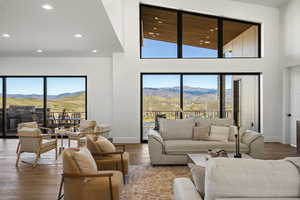 Living room featuring high vaulted ceiling, a mountain view, hardwood / wood-style flooring, and recessed lighting