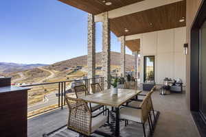 Balcony featuring outdoor dining area and a mountain view