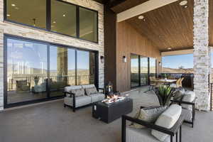 View of patio / terrace featuring an outdoor living space with a fire pit and outdoor dining area